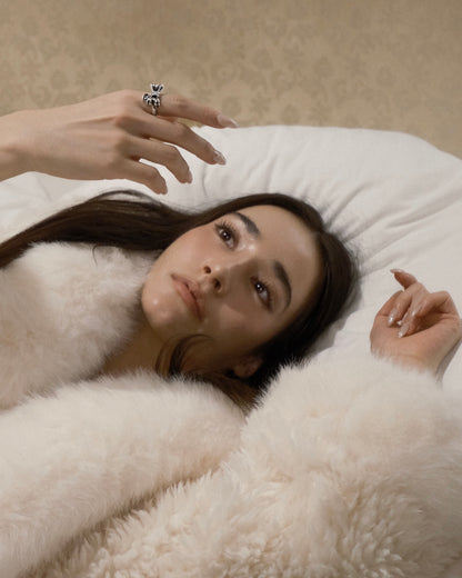 Oxidized 925 silver bow ring worn on hand, subtle charm dangle, hand-finished in Japan.